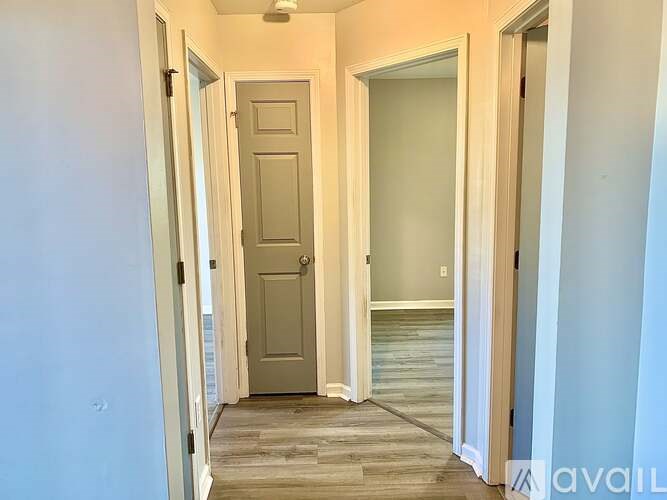 A hallway with a door on the left and a glass door on the right.