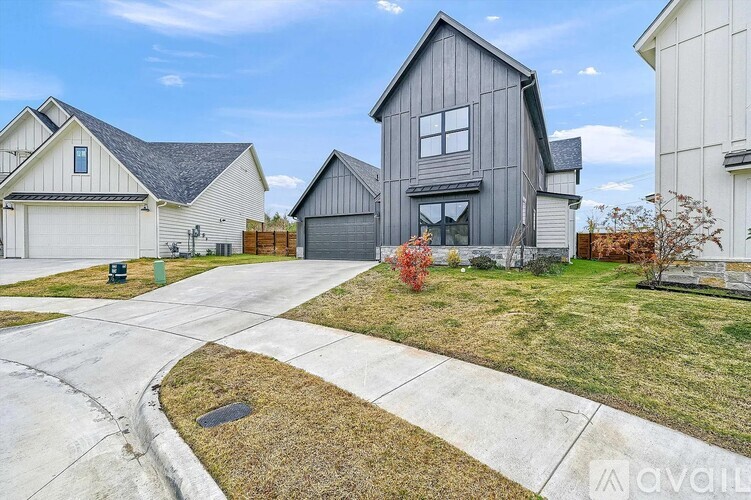 A modern house with a grey exterior is available for sale.