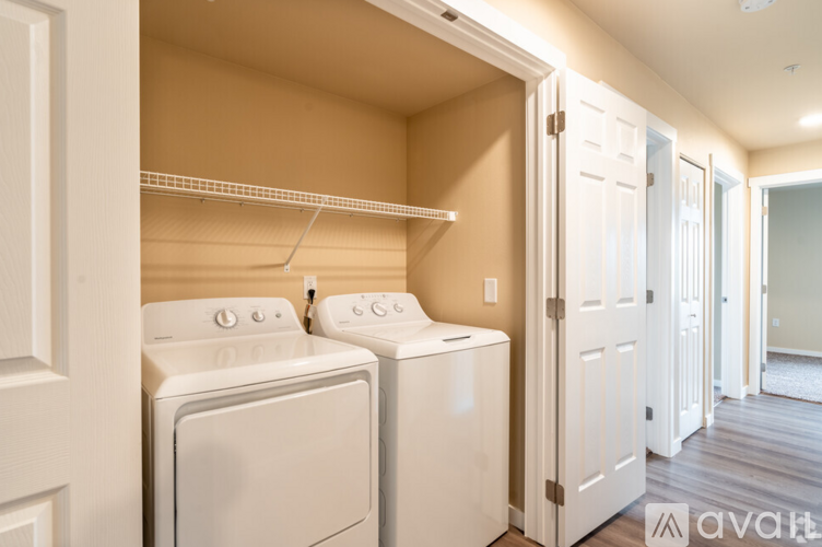 A small laundry room with a washer and dryer.