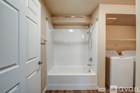A white bathroom with a tub and toilet.
