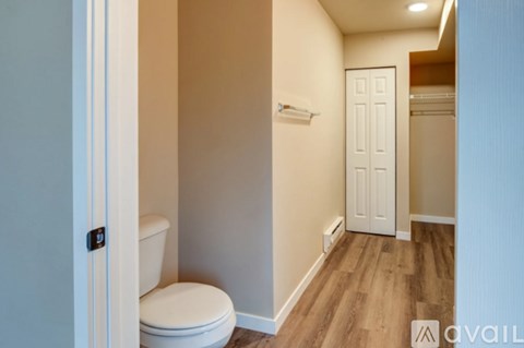 A small bathroom with a toilet and a door.