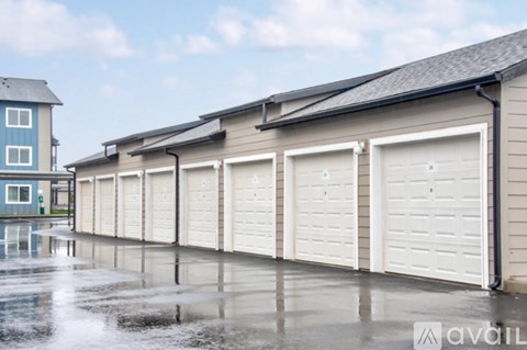 A row of white garage doors are closed.