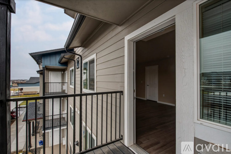 A balcony with a black railing and a view of the water.