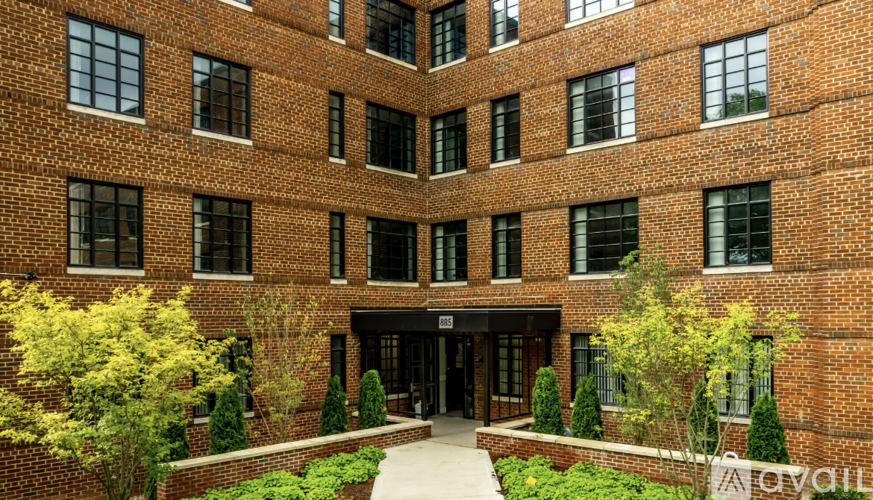 A brick building with a courtyard in front.