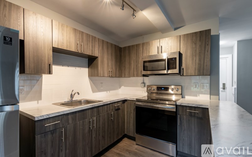 A kitchen with wooden cabinets and stainless steel appliances.