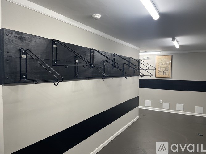 A gym with a row of pull up bars on the wall.
