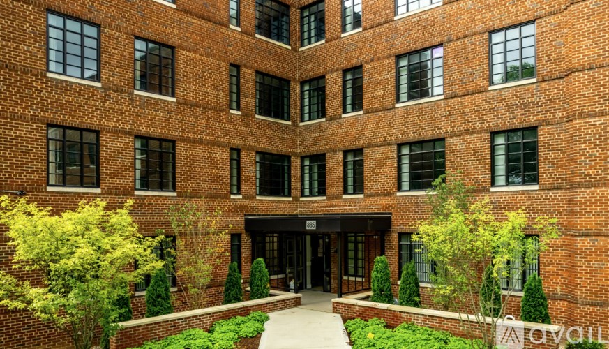 A brick building with a courtyard in front.