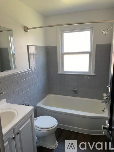 A bathroom with a toilet, sink, and bathtub.