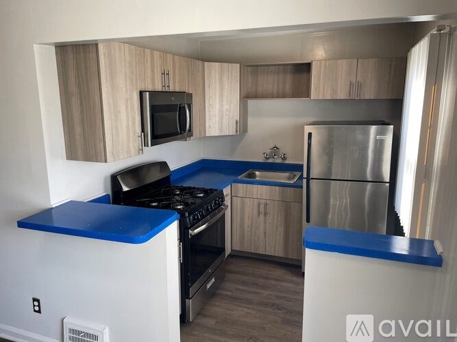 A kitchen with a blue counter top and stove.
