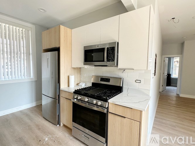A kitchen with a stove, oven, refrigerator, and microwave.