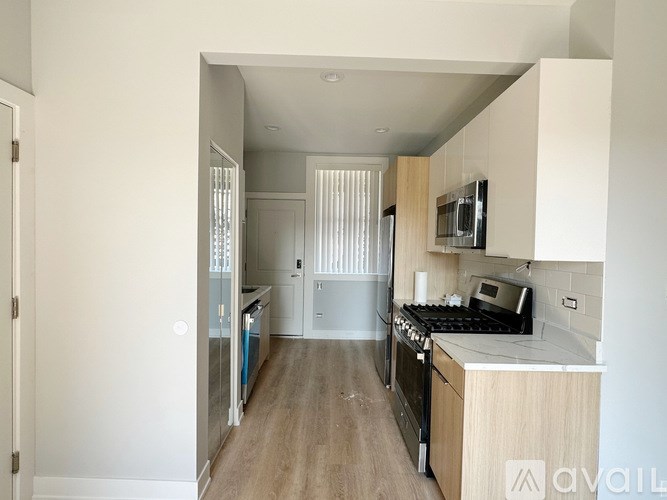 A kitchen with a stove top oven and a refrigerator.