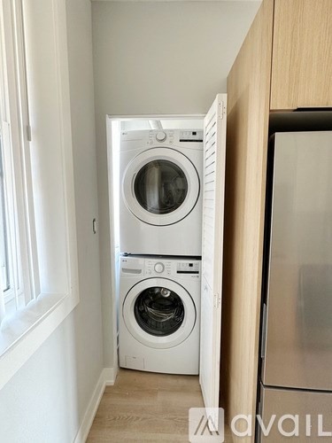 A white washing machine and dryer in a small laundry room.