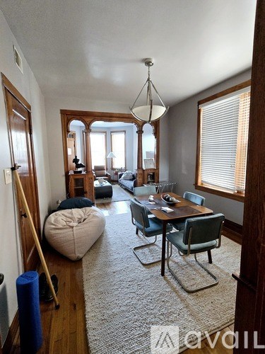 A living room with a dining table and chairs.