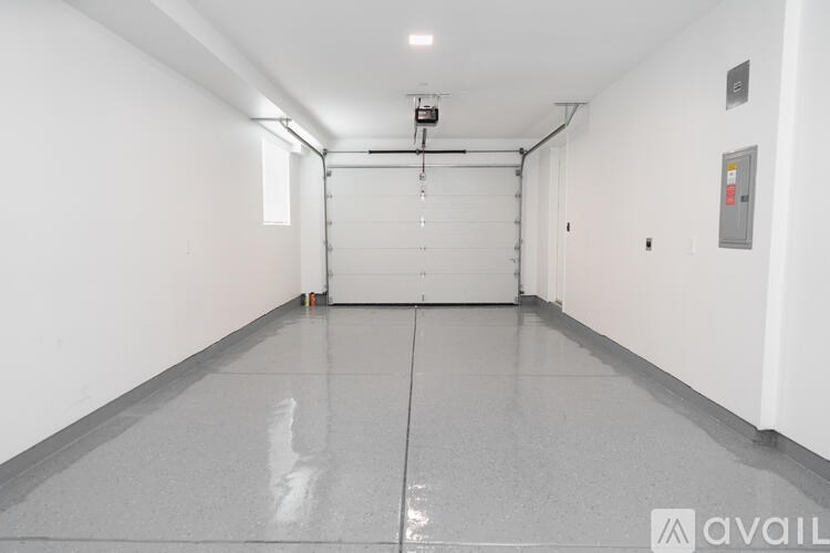A long, empty hallway with a closed door at the end.