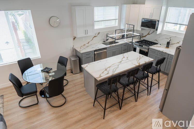 A kitchen with a table and chairs in the middle of the room.