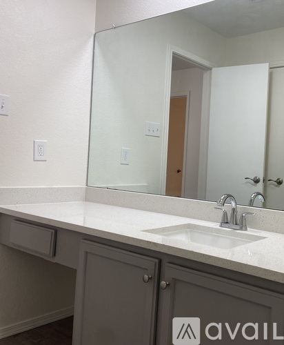 A bathroom with a sink and a mirror.
