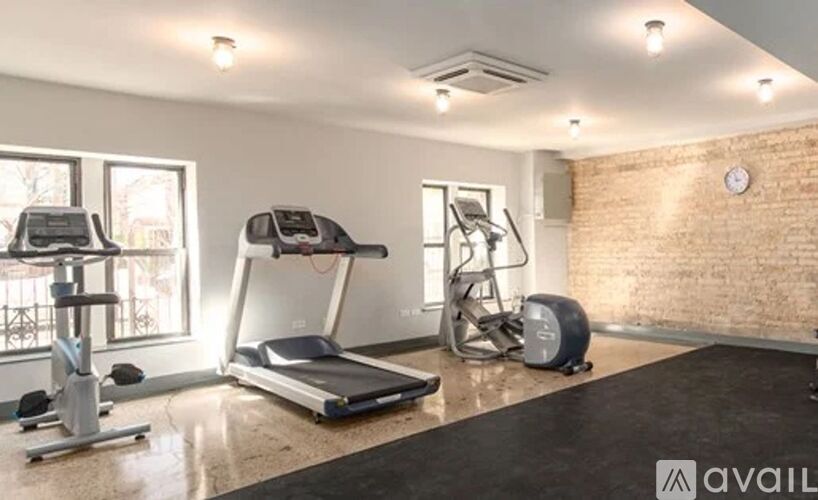 A gym with treadmills, elliptical machines, and a stationary bike.