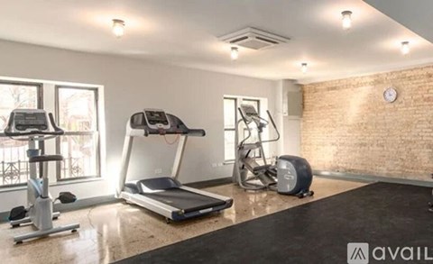 A gym with treadmills, elliptical machines, and a stationary bike.