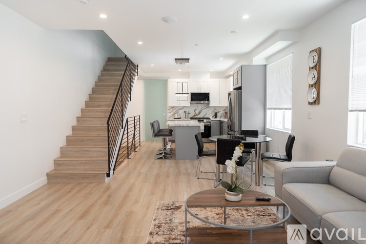 A living room with a staircase leading to the upper floor.