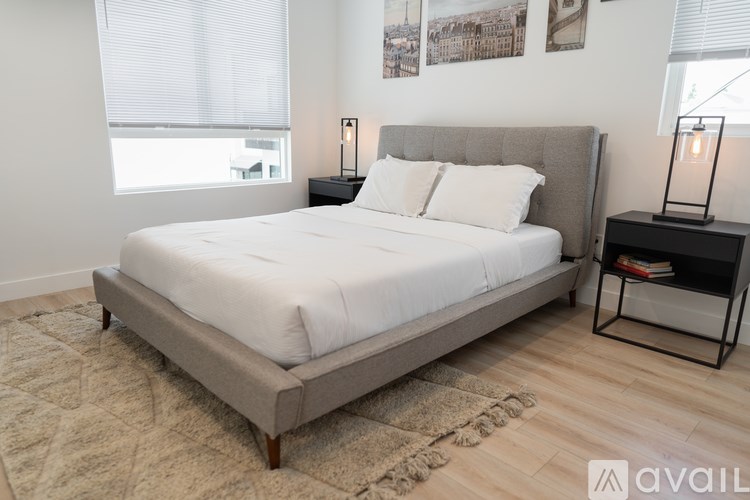 A bedroom with a large bed and a window.