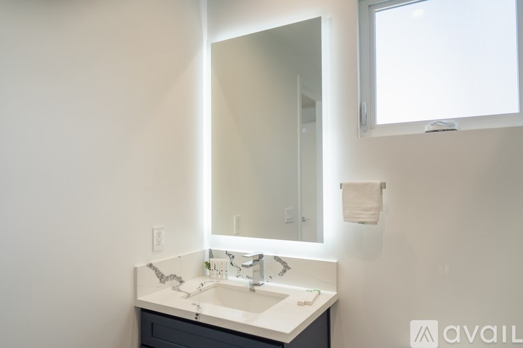 A bathroom with a sink and mirror.