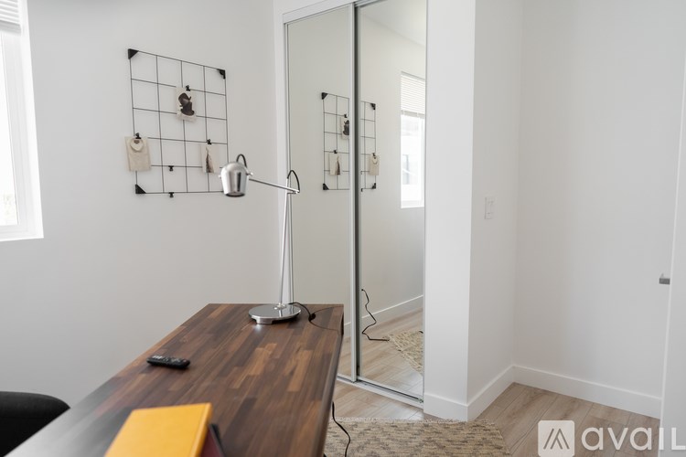 A bathroom with a wooden vanity and a glass shower door.