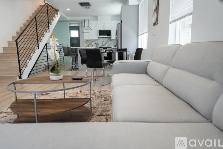 A living room with a grey couch and a coffee table.