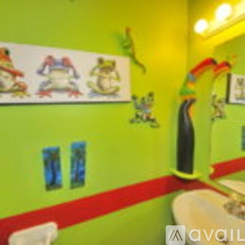 A bathroom with green walls and a white sink.