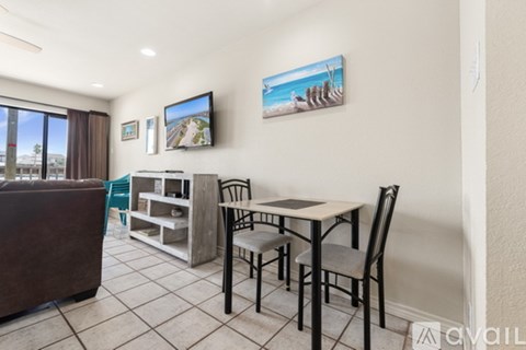 A dining area with a table and chairs is shown in the image.