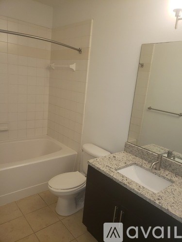 A bathroom with a toilet, sink, and bathtub.