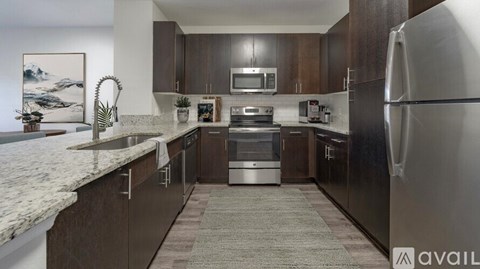 A modern kitchen with a refrigerator on the right side.
