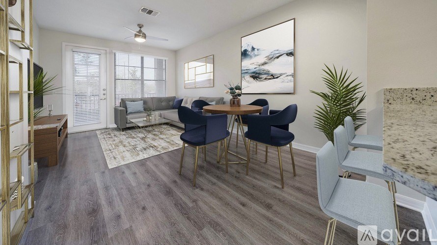 A living room with a grey sofa, a wooden table, and a painting on the wall.