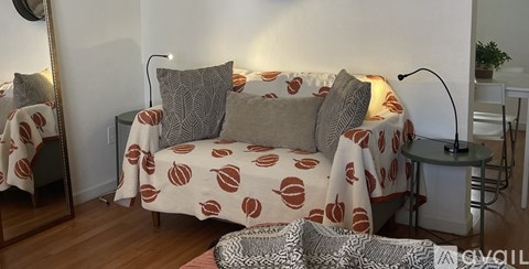 A living room with a couch, a chair, and a table.