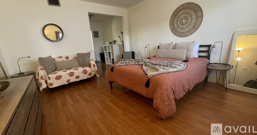 A bedroom with a bed and a couch.