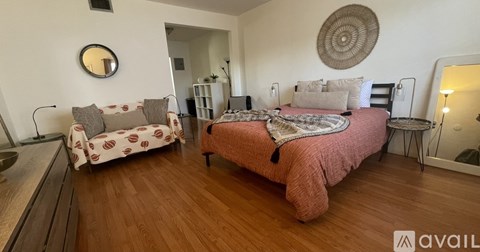 A bedroom with a bed and a couch.