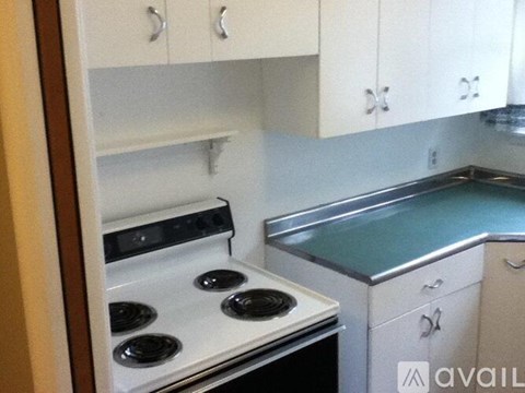 A kitchen with a stove and a sink.