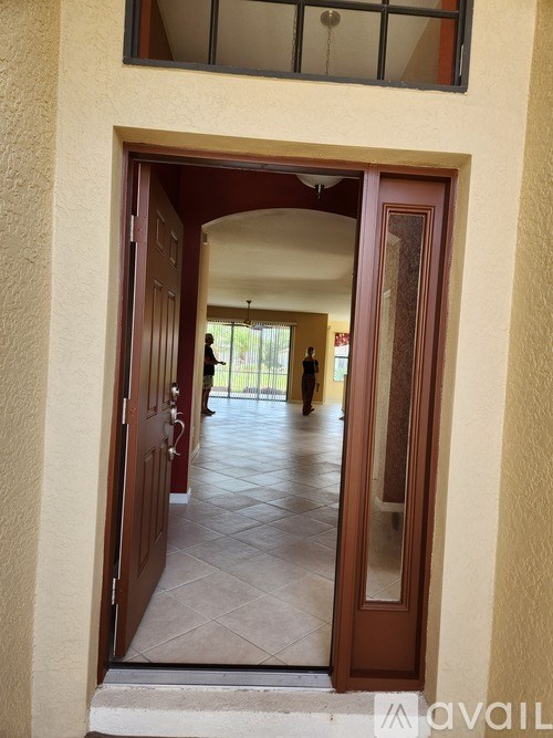 A person is walking through a doorway into a hallway.