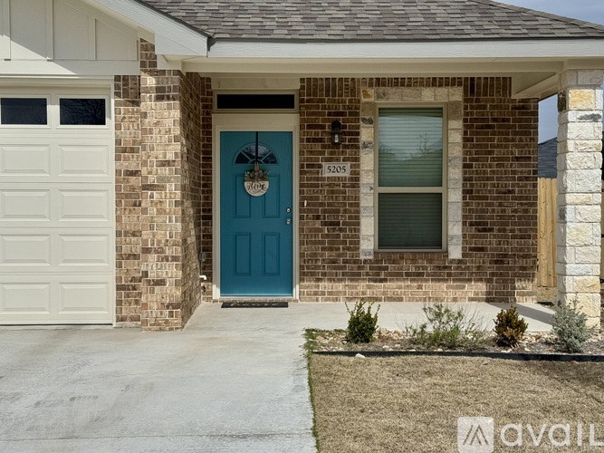 A house with a blue door and a garage door.