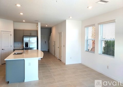 A kitchen with a counter and cabinets is available for rent.