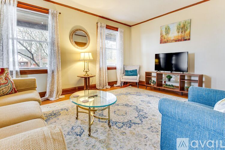 A living room with a glass table and a television.