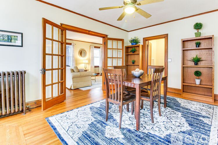 A dining room with a table set for four.