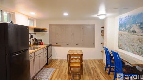 A room with a red door and wooden flooring.
