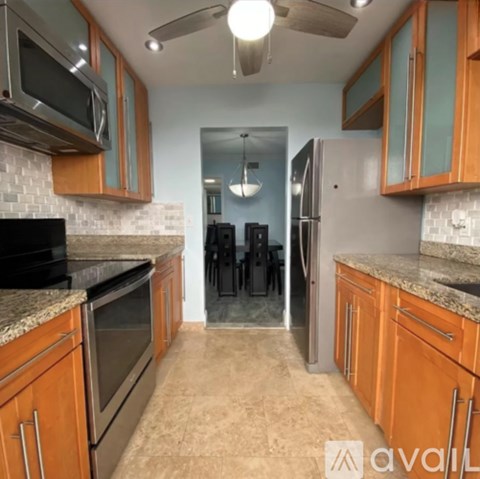 A kitchen with wooden cabinets and a black stove top oven.