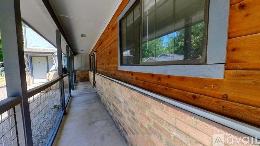 A balcony with a railing and a brick wall.