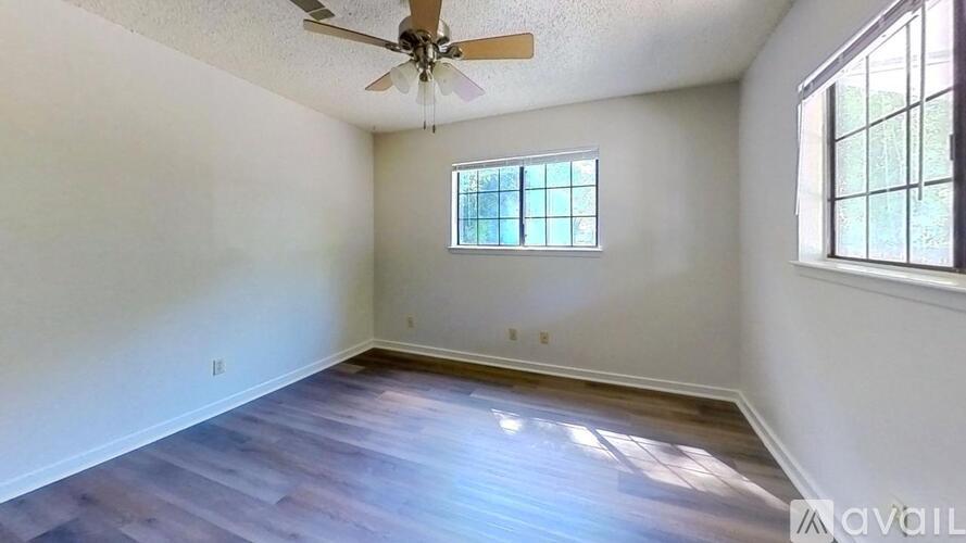 A room with a ceiling fan and a window.