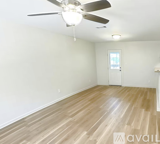 A 3D image of a house interior with a kitchen, living room, and two bedrooms.