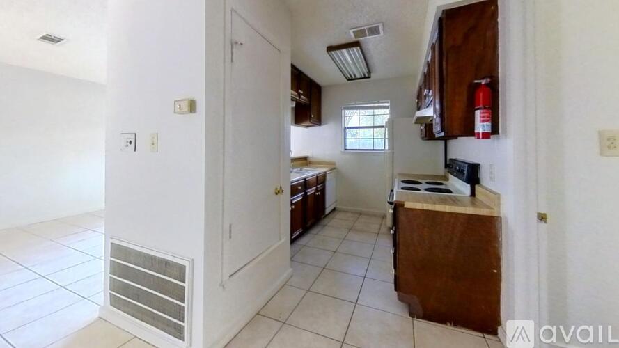 A kitchen with white walls and a white door.