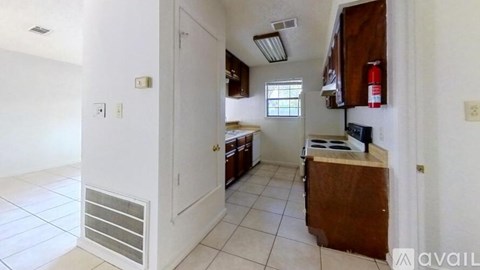 A kitchen with white walls and a white door.
