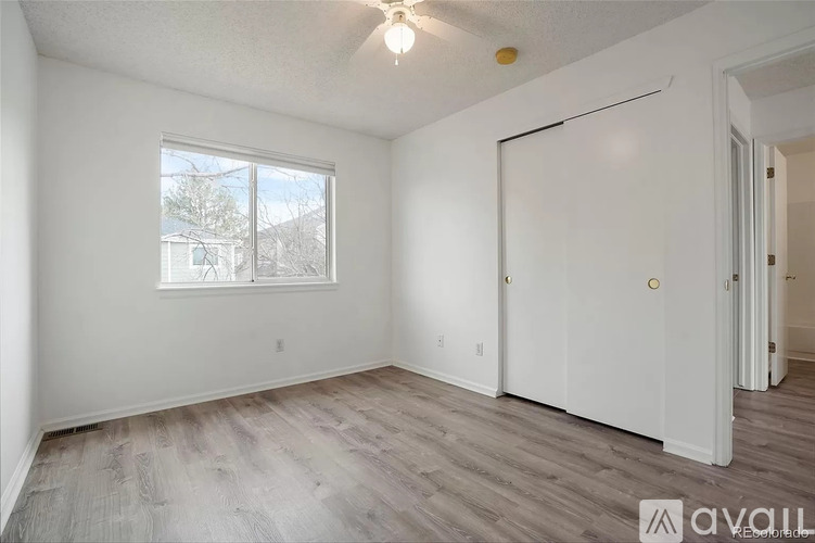 A room with a window and a door is available for rent.