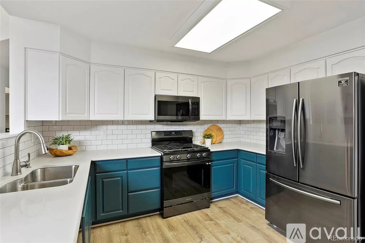 A kitchen with white cabinets and a black stove top oven.